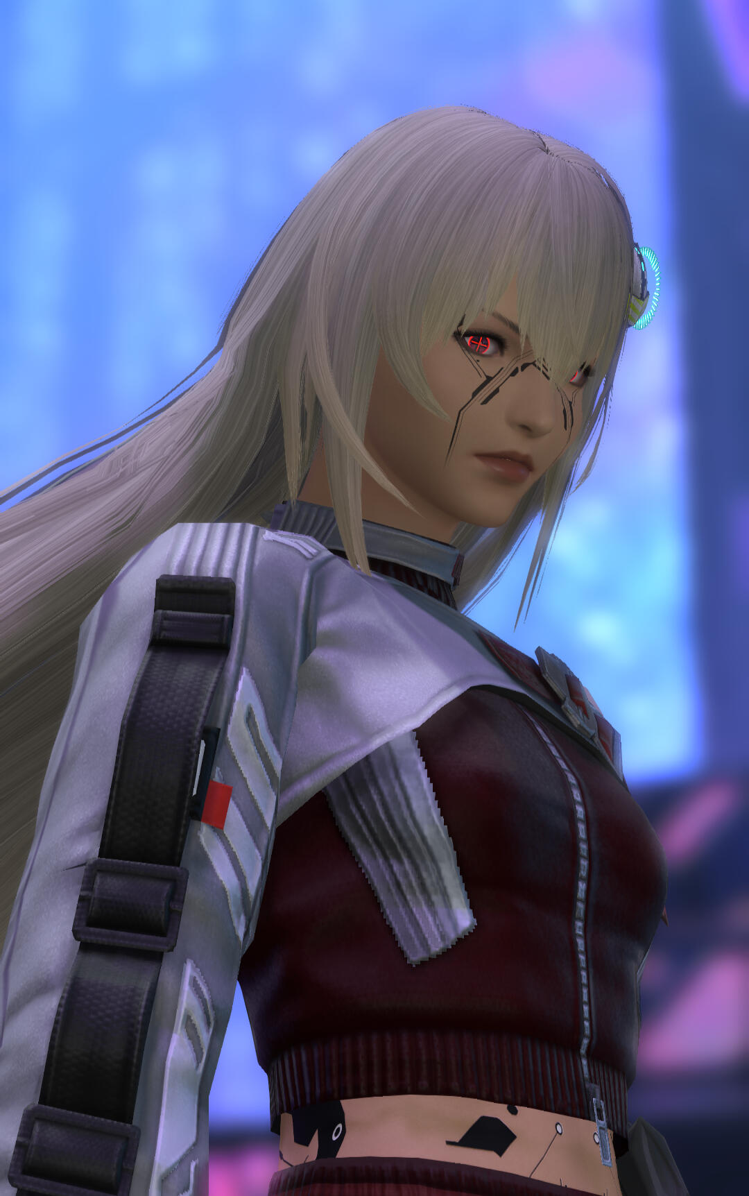 A long-haired blonde woman with fair skin stares into the camera. Her eyes are an intense red, and her pupils resemble a crosshair. She's wearing a dark red futuristic crop-top with long silver sleeves.